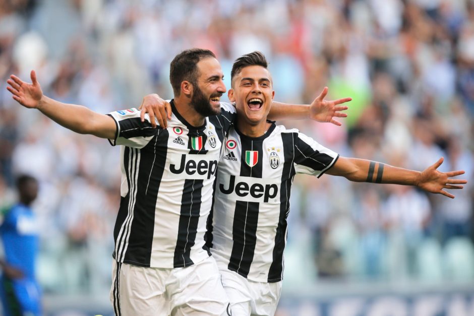 Juventus' Argentinian forward Gonzalo Higuain (L) celebrates with teammate Argentinian forward Paulo Dybala after scoring a goal during the Italian Serie A football match between Juventus and Sassuolo on September 10, 2016 at the Juventus Stadium in Turin.  / AFP / MARCO BERTORELLO        (Photo credit should read MARCO BERTORELLO/AFP/Getty Images)