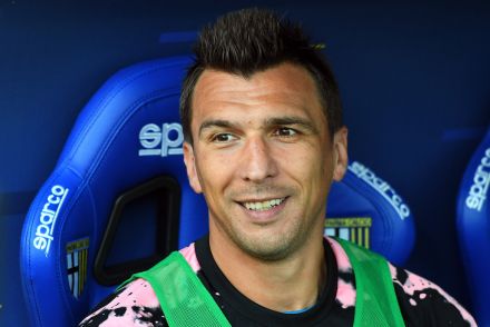 Mario Mandzukic smiling in the dugout