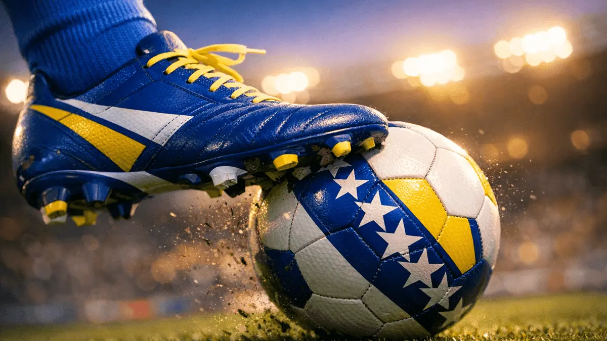 Football boot striking match ball in stadium, blue and yellow national colours, floodlit evening lighting.