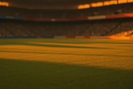 Floodlit stadium pitch at dusk with golden and emerald atmospheric lighting, dramatic shadows, packed stands, no people visible.