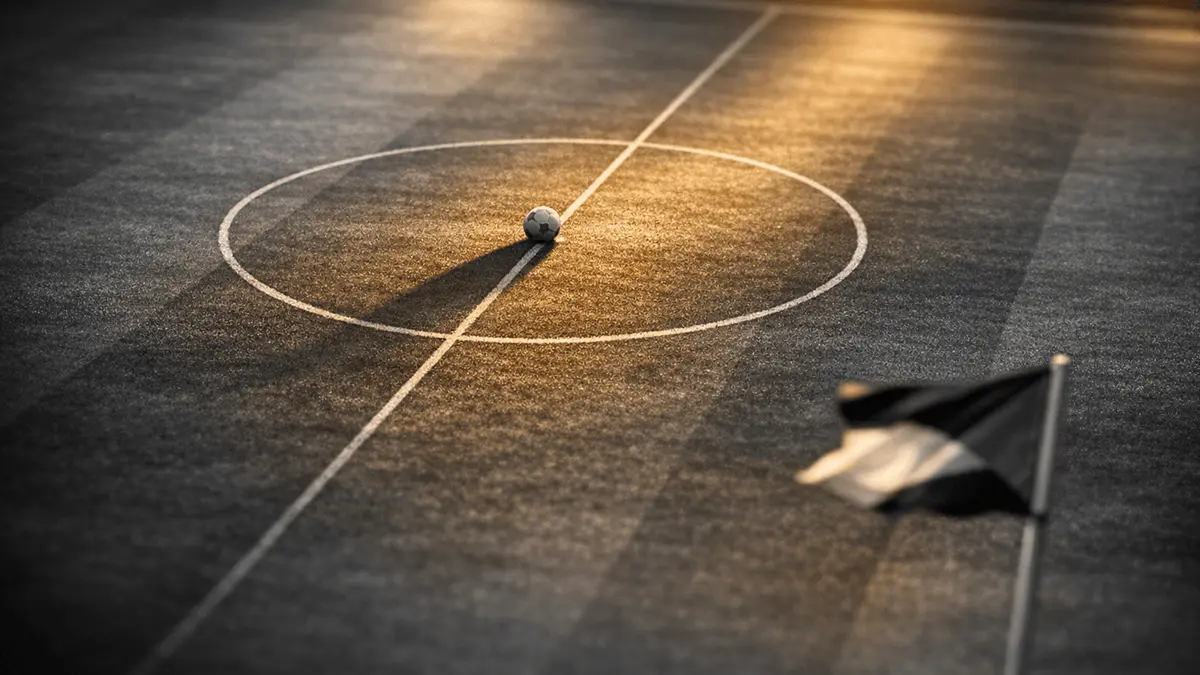 Floodlit football pitch at dusk, centre spot with match ball, golden-hour lighting, black and gold colour grade.