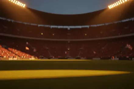 Floodlit football stadium at dusk with packed stands and dramatic golden-hour lighting, empty pitch visible.