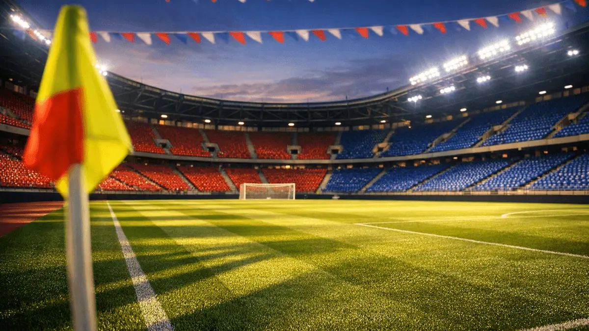 Empty stadium corner with crimson and azure seating under evening floodlights, dramatic shadows across pitch.