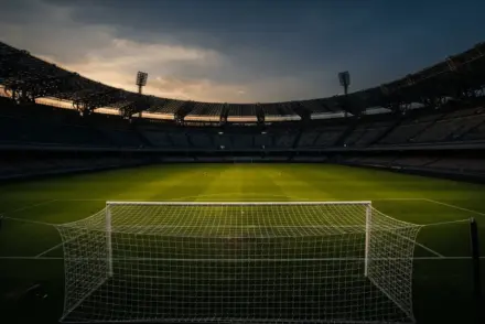 Stadio Maradona at dusk with dramatic golden light across the pitch, suggesting transfer anticipation