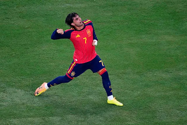 Ferran Torres celebrating in the Spain national team jersey during a match.