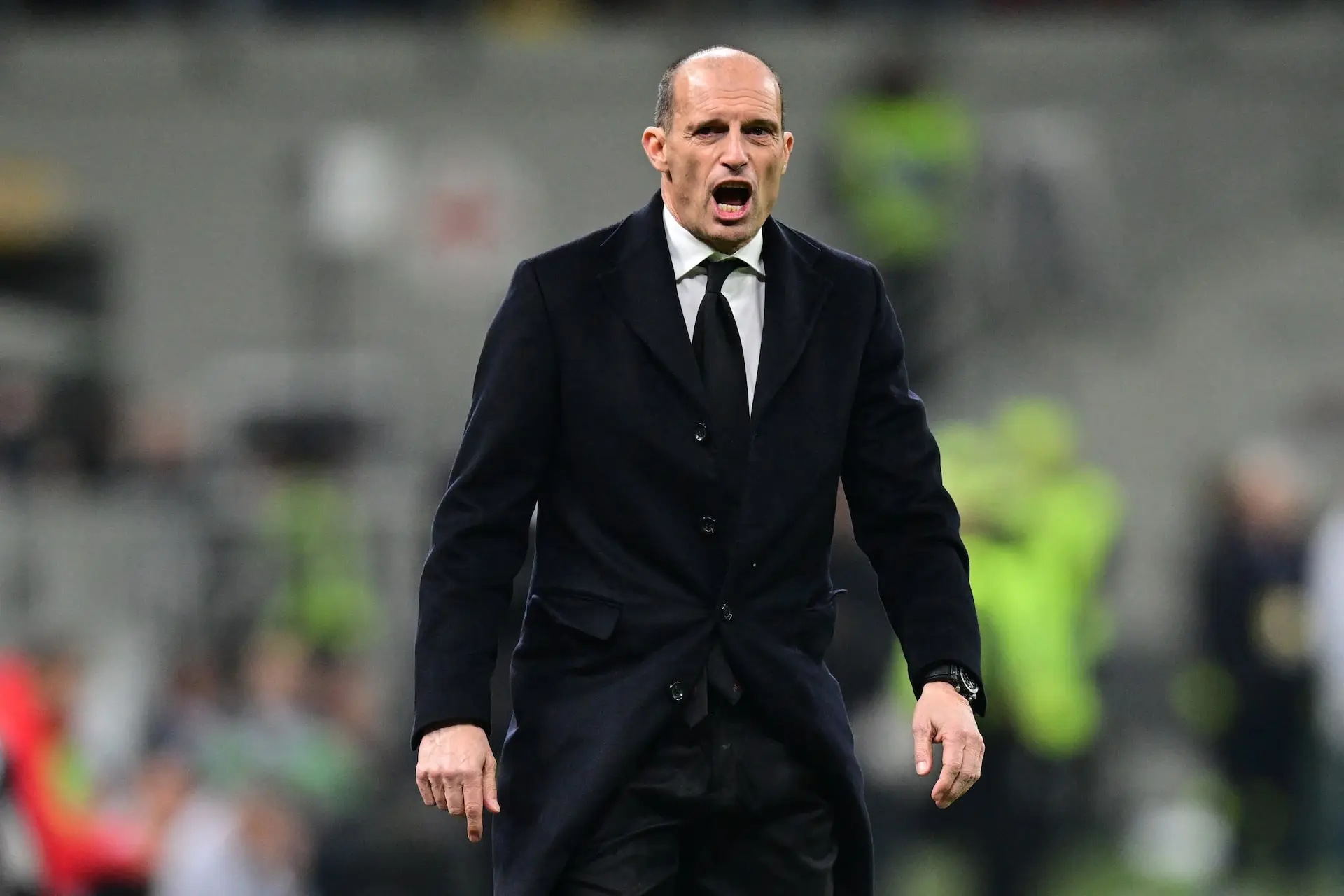 Massimiliano Allegri passionately coaching during a football match.