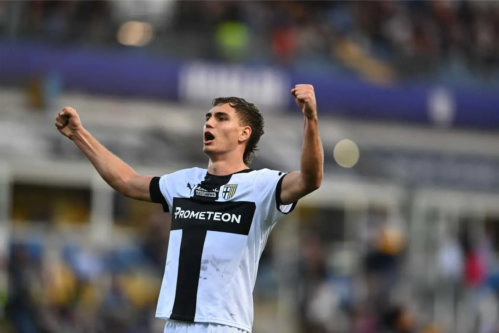 Mateo Pellegrino celebrating in Parma's football kit during a match.