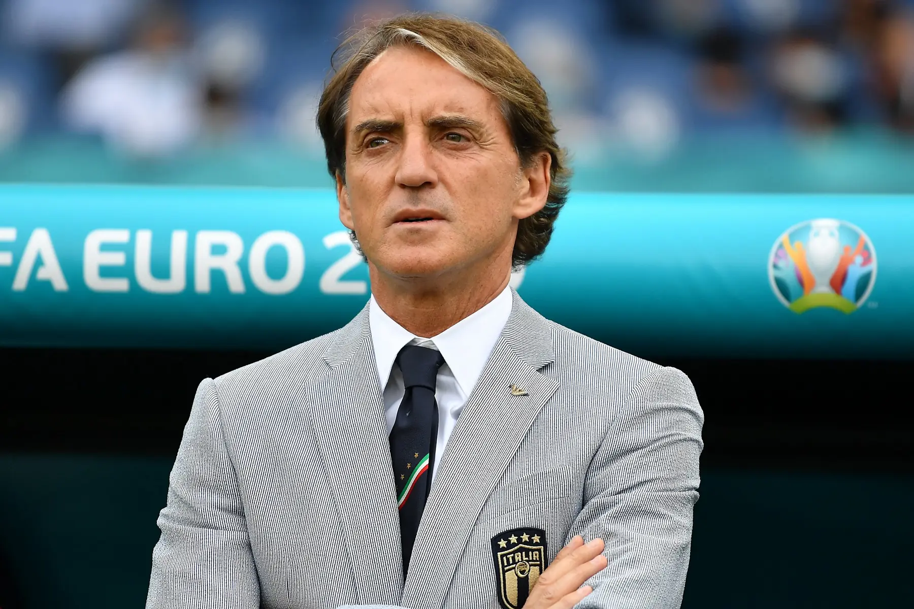 Roberto Mancini, Italy football manager, in a grey blazer during a match.