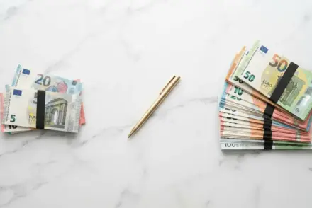 Euro banknote stacks on marble surface showing valuation gap in transfer negotiations