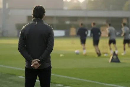 Former Italian defender observing a football training session in a coaching role