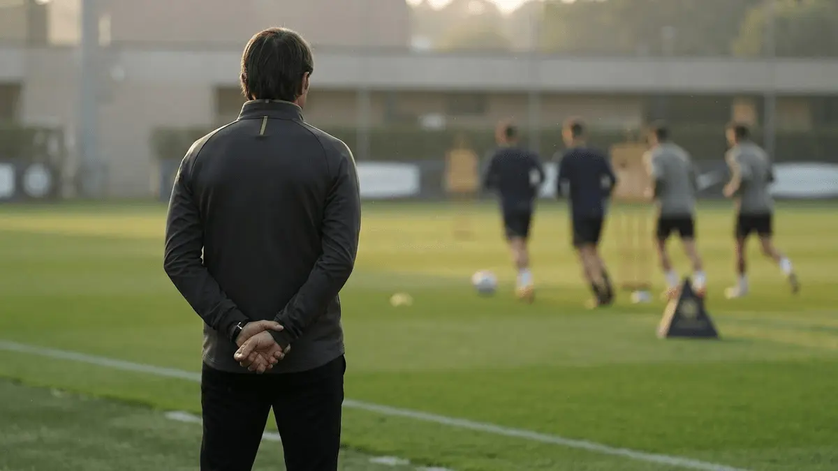 Former Italian defender observing a football training session in a coaching role