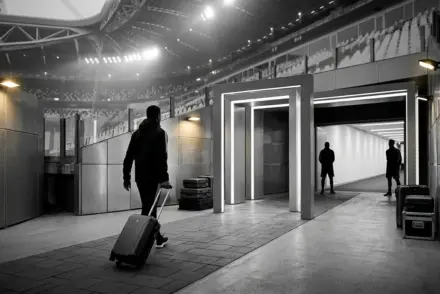 Editorial football transfer scene showing a three-way striker move through connected stadium pathways