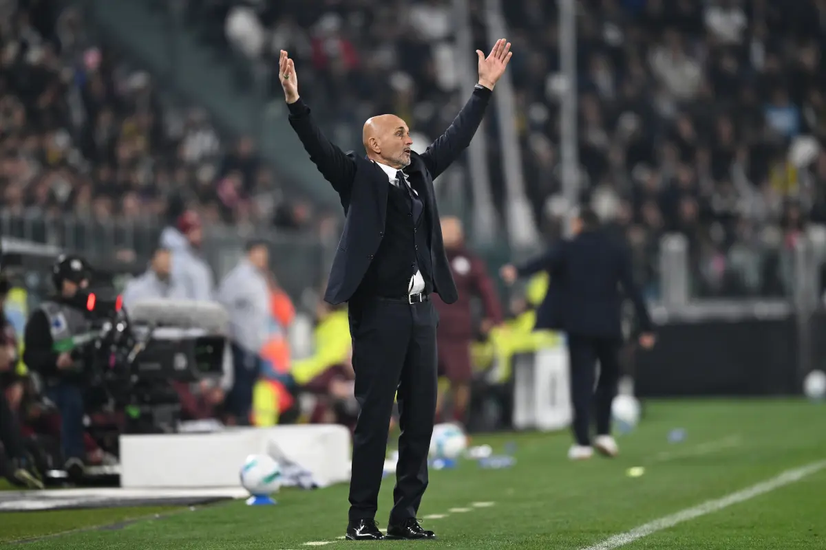 Luciano Spalletti standing on the touchline with arms raised during a football match