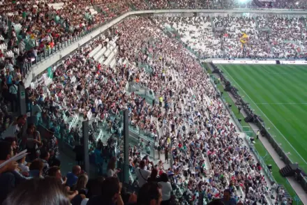 A wide view of the stands filled with fans at the Juventus Stadium.
