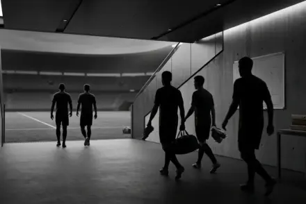 Anonymous footballers moving through a stadium tunnel to represent Juventus squad reshaping through loans and free exits