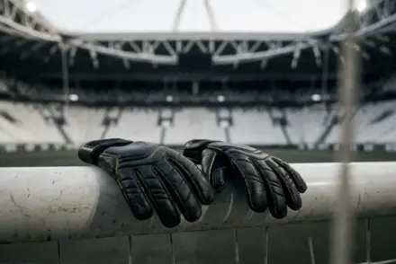 Goalkeeper gloves on a football goal representing Neto's return to Juventus amid a goalkeeping shortage