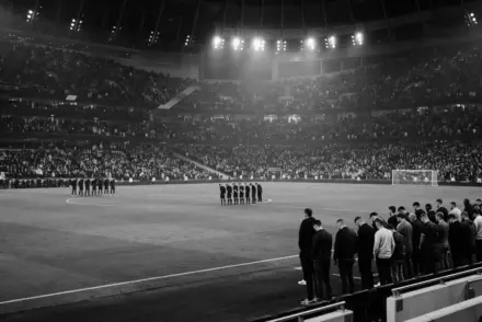 Stadium tribute disrupted by a small supporter section during a solemn minute of silence